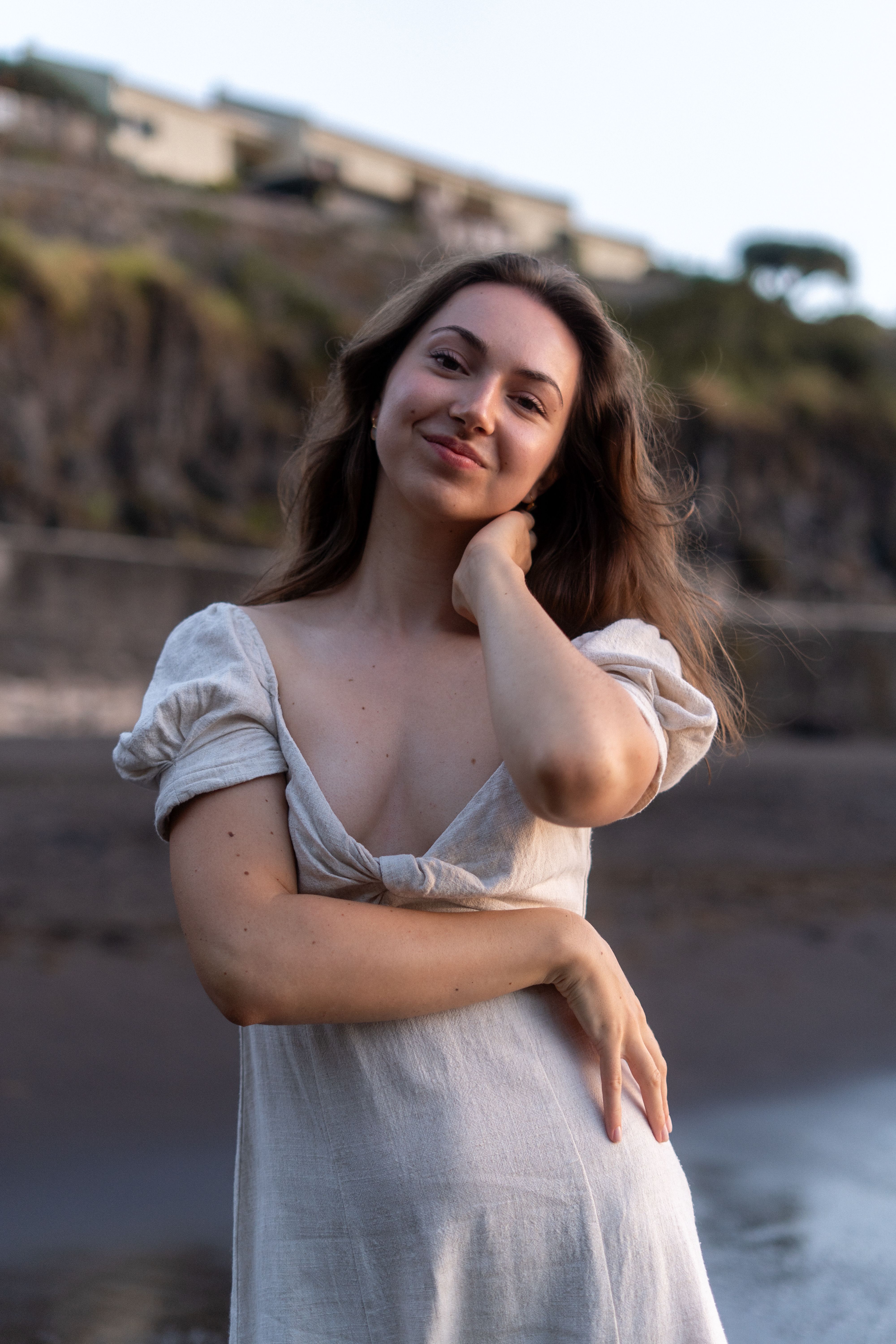 Woman in a white dress standing on a beach