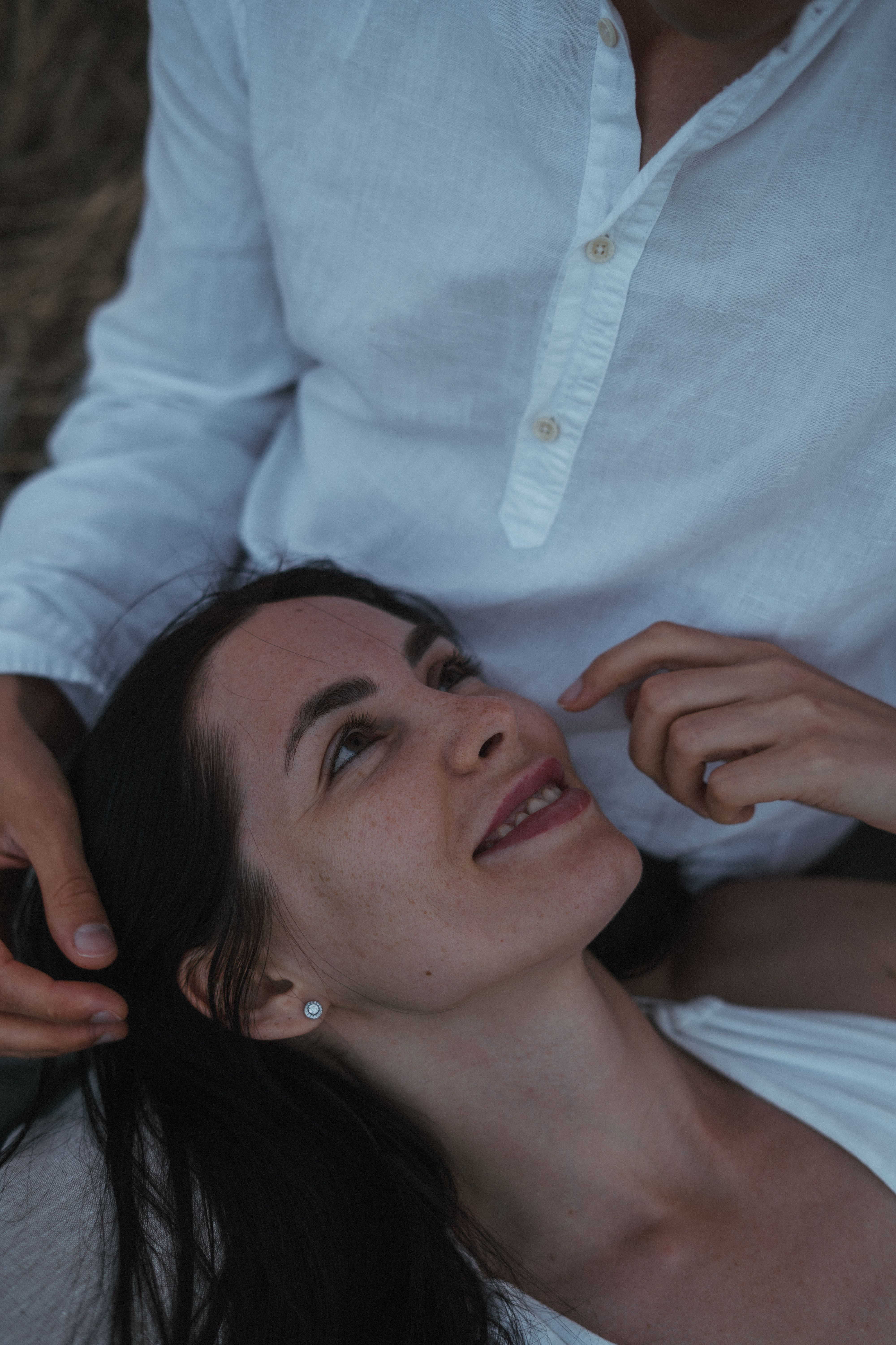 Woman resting her head in a partner's lap